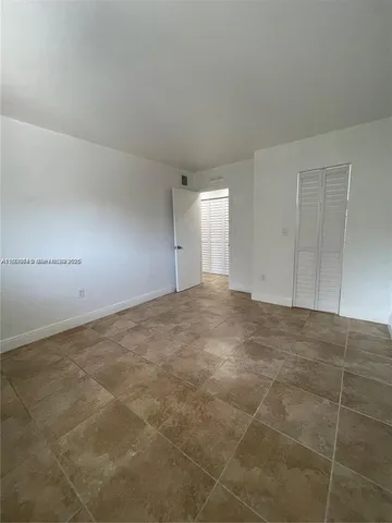 a white toilet sitting next to a bathroom sink and a mirror