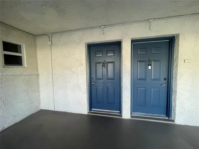 a living room with furniture a flat screen tv and a window