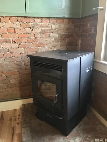a close view of a sink and a stove with wooden floor