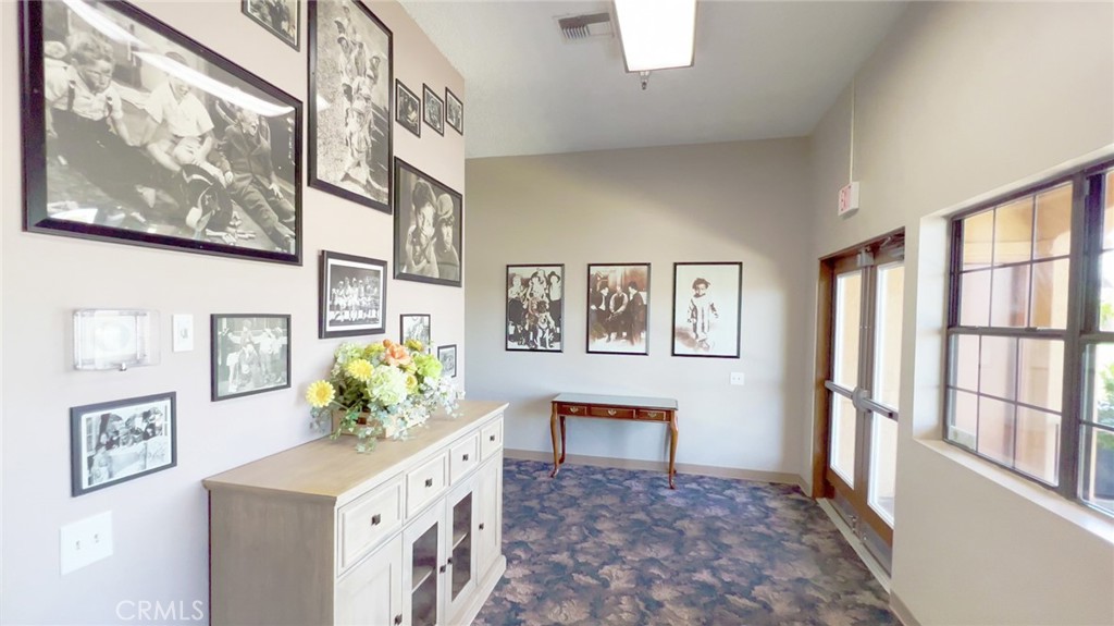 69801 Ramon Road, Unit 38 Cathedral City, CA 92234 - Photo 29 of 47 a hallway with painting and wooden floor