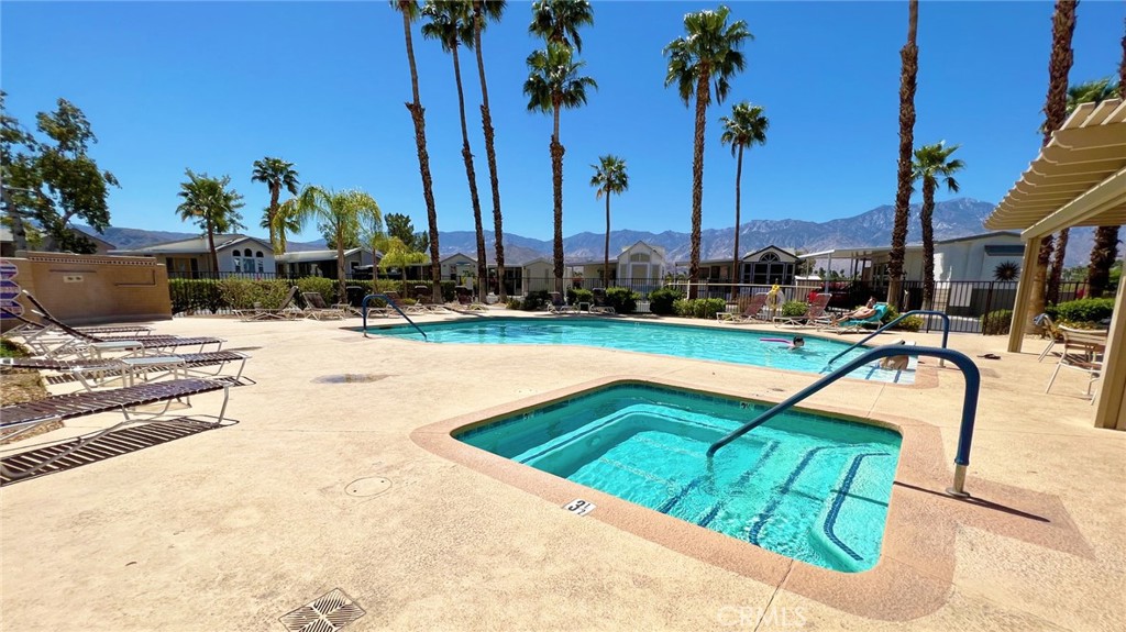 69801 Ramon Road, Unit 38 Cathedral City, CA 92234 - Photo 36 of 47 a view of a swimming pool with a lounge chairs