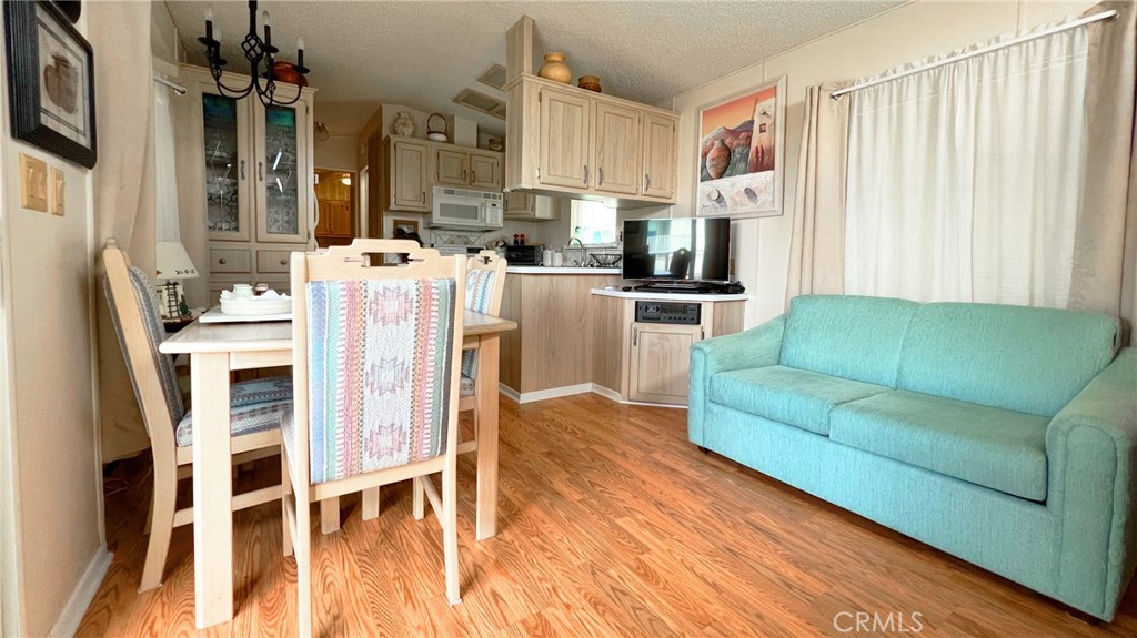 69801 Ramon Road, Unit 38 Cathedral City, CA 92234 - Photo 7 of 47 a living room with furniture a flat screen tv and kitchen view