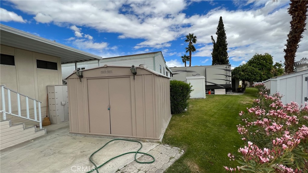 69801 Ramon Road, Unit 38 Cathedral City, CA 92234 - Photo 9 of 47 a backyard of a house with plants and barbeque oven