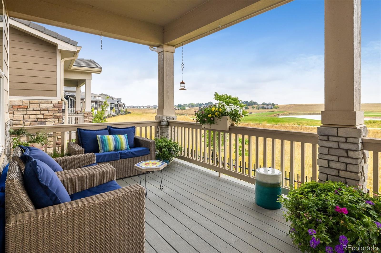 a balcony with furniture and wooden floor