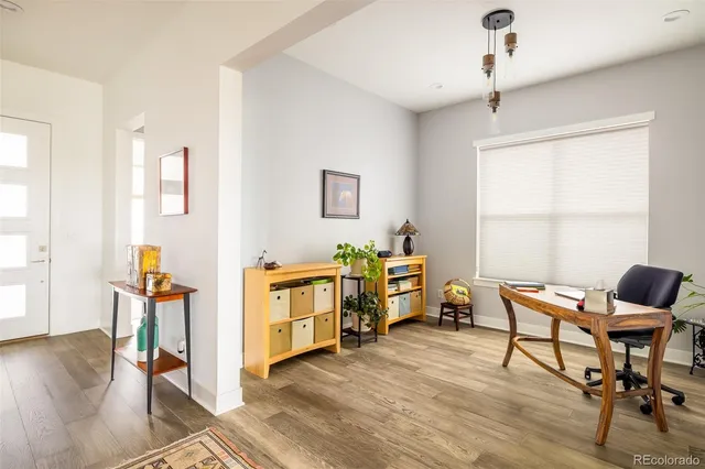a view of a workspace with furniture and a window