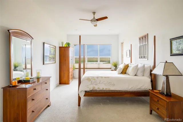 a bedroom with a bed dresser and a large mirror