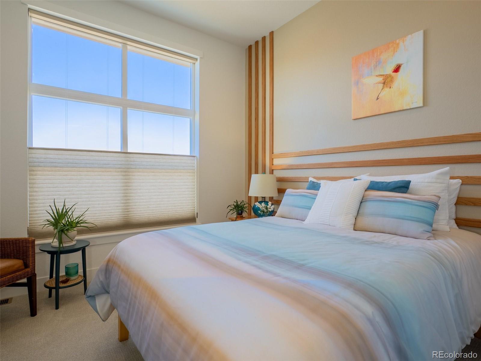 2940 Newfound Lk Road Berthoud, CO 80513 - Photo 21 of 42 a bedroom with a bed and a potted plant