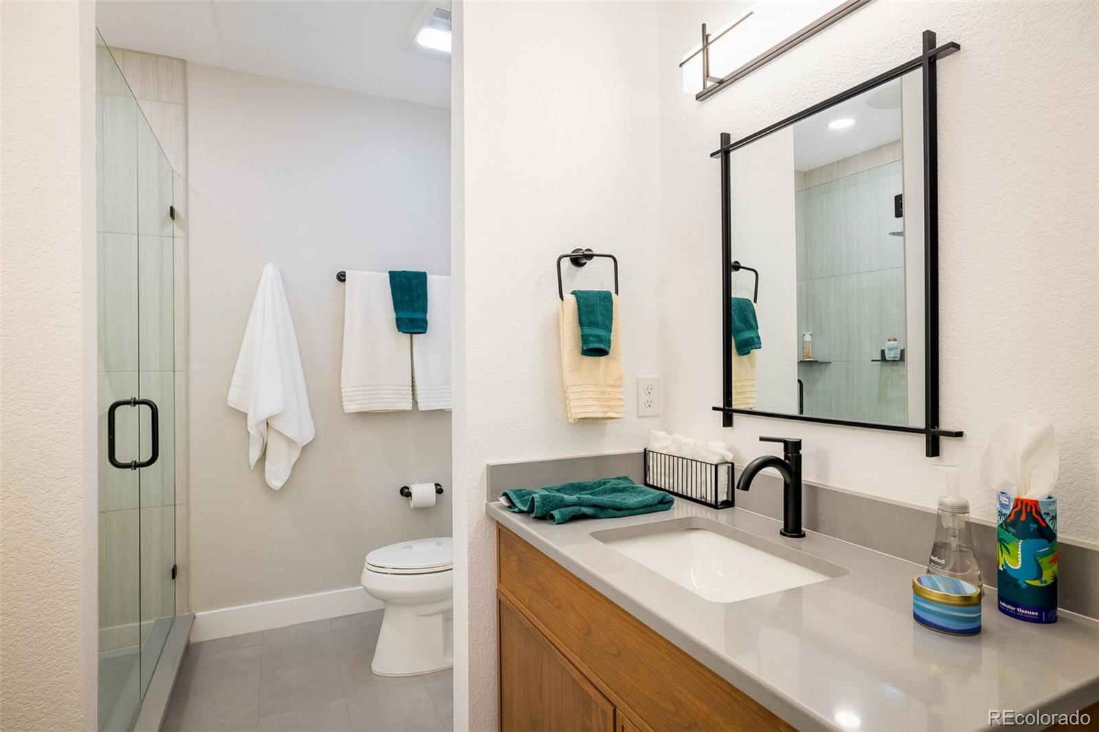2940 Newfound Lk Road Berthoud, CO 80513 - Photo 32 of 42 a bathroom with a granite countertop sink a toilet and shower
