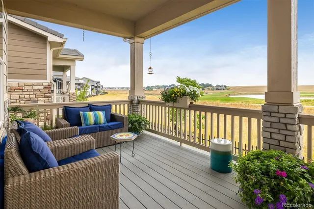 a balcony with furniture and wooden floor