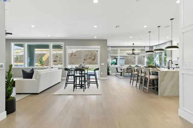 a large kitchen with lots of counter space and furniture