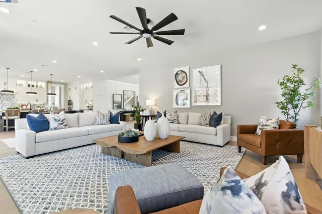 a kitchen with stainless steel appliances kitchen island granite countertop a table and chairs