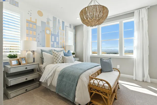 a kitchen with kitchen island a large counter top space a sink stainless steel appliances and windows