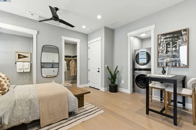 a kitchen with granite countertop white cabinets and white stainless steel appliances