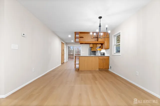 a view of a kitchen with a sink cabinets and wooden floor