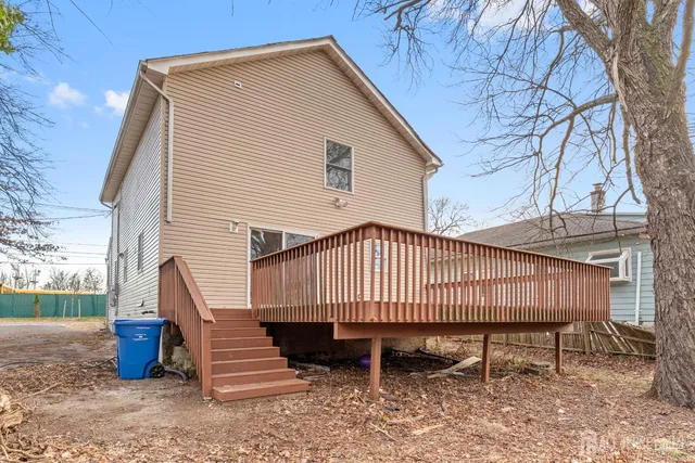 a view of a chairs and table in the backyard