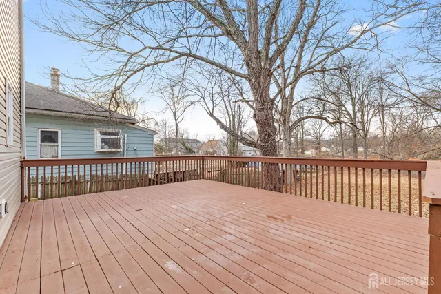 a view of backyard with a deck and wooden floor