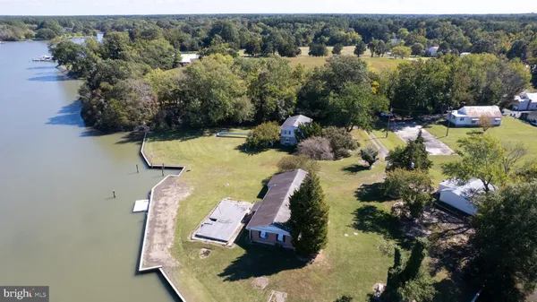 an aerial view of a house with a yard and lake view