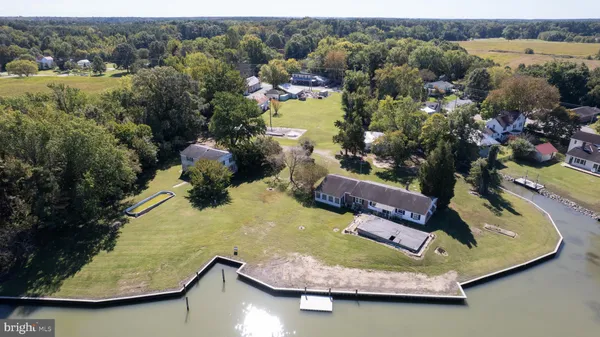 an aerial view of a house with a yard lake view and mountain view