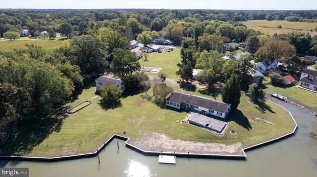 an aerial view of a house with a yard lake view and mountain view