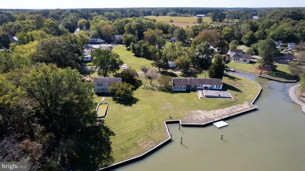 an aerial view of a house with a garden and swimming pool
