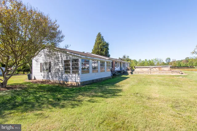 a view of a house with swimming pool and a yard