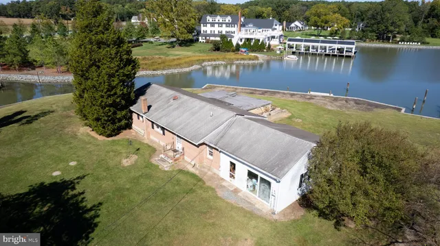 a view of a swimming pool with outdoor seating and lake view