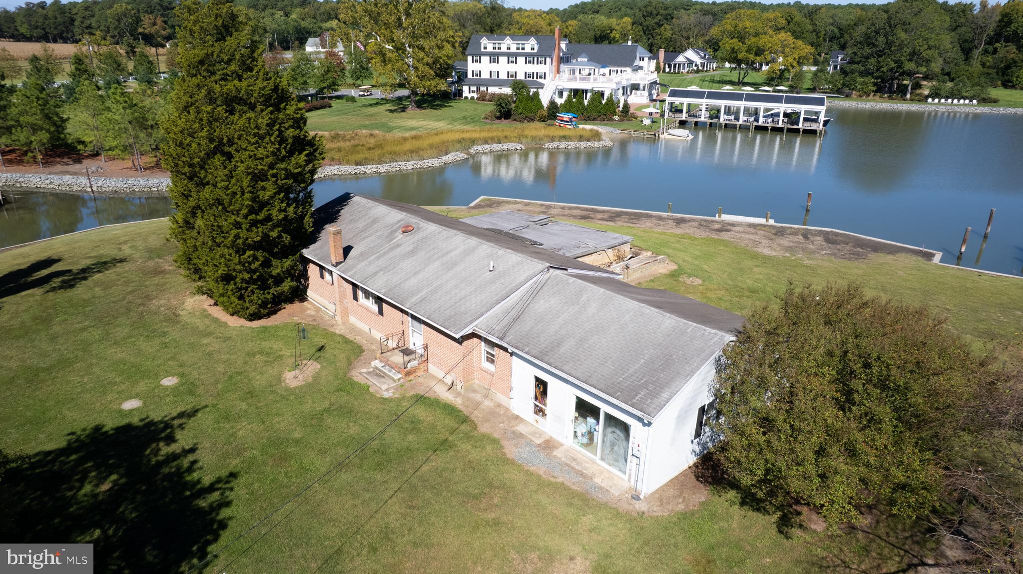 7049 Acorn Alley Newcomb, MD 21653 - Photo 30 of 40 a view of a swimming pool with outdoor seating and lake view