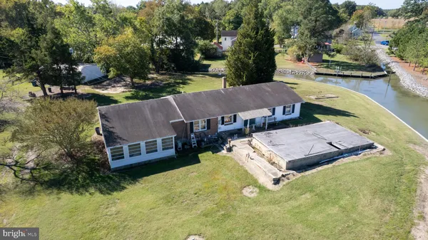 an aerial view of a house with swimming pool garden and patio