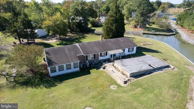 an aerial view of a house with swimming pool garden and patio