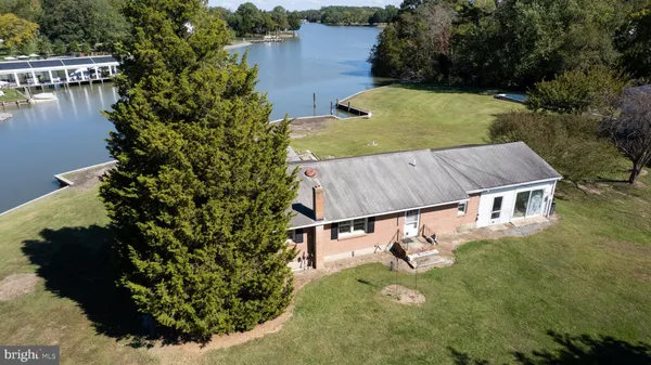 an aerial view of a house with a yard basket ball court and outdoor seating