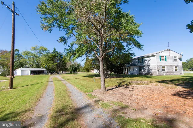 a view of yard with swimming pool and seating space