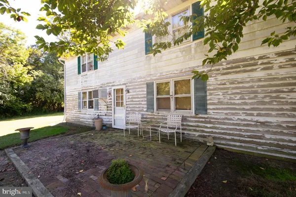 a backyard of a house with barbeque oven