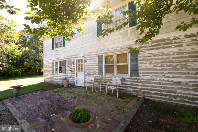 a backyard of a house with barbeque oven