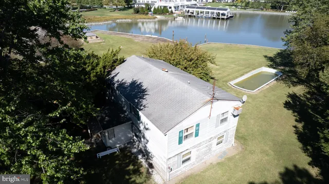 an aerial view of a house with a lake view