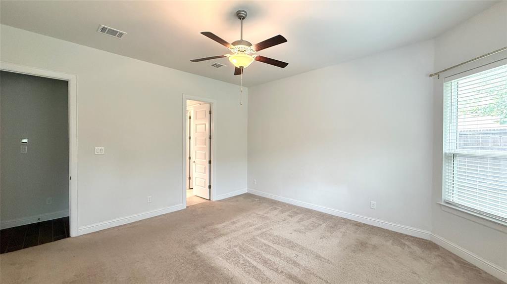 601 C-Bar Ranch Trail, Unit 27 Cedar Park, TX 78613 - Photo 11 of 29 Spacious room featuring neutral carpeting, a ceiling fan with light fixture, and a window with blinds