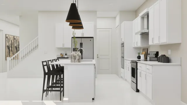a kitchen with stainless steel appliances kitchen island a table chairs in it and white cabinets
