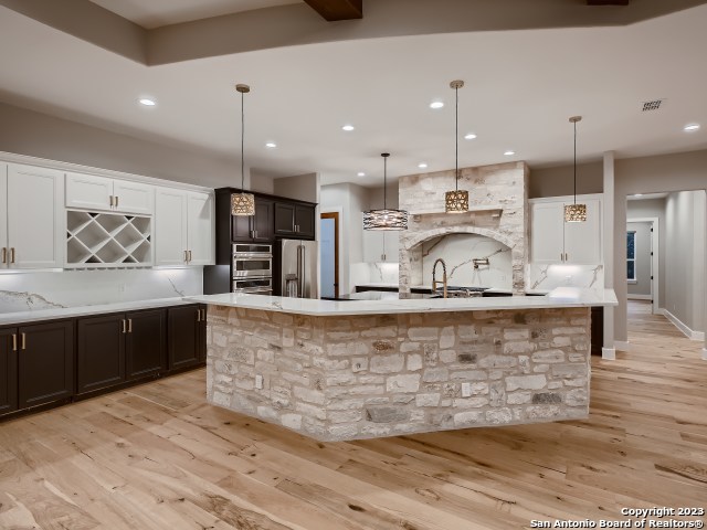 208 River Ridge Boerne, TX 78006 - Photo 11 of 38 a large kitchen with kitchen island a counter top stainless steel appliances and cabinets