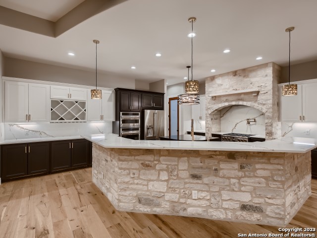 208 River Ridge Boerne, TX 78006 - Photo 13 of 38 a large kitchen with kitchen island a sink stainless steel appliances and cabinets