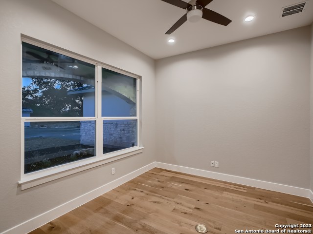 208 River Ridge Boerne, TX 78006 - Photo 14 of 38 an empty room with wooden floor and a ceiling fan