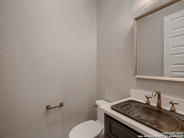 208 River Ridge Boerne, TX 78006 - Photo 15 of 38 a bathroom with a granite countertop toilet and sink
