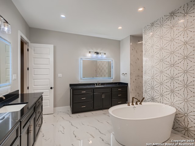 208 River Ridge Boerne, TX 78006 - Photo 17 of 38 a spacious bathroom with a bathtub sink mirror and toilet