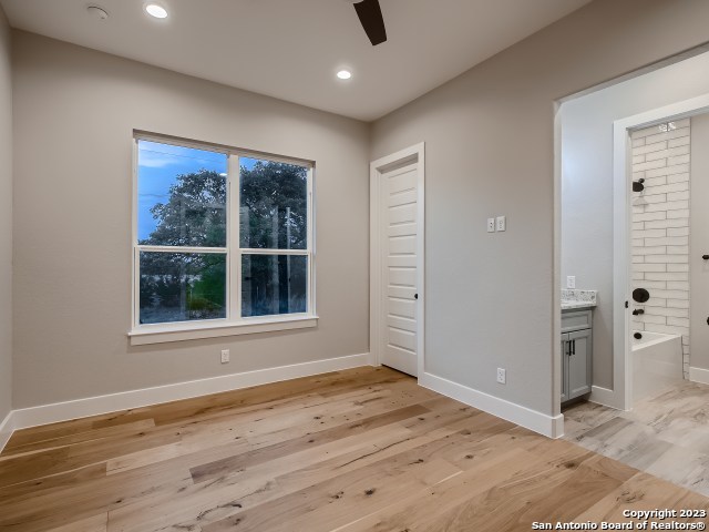 208 River Ridge Boerne, TX 78006 - Photo 19 of 38 an empty room with wooden floor and windows