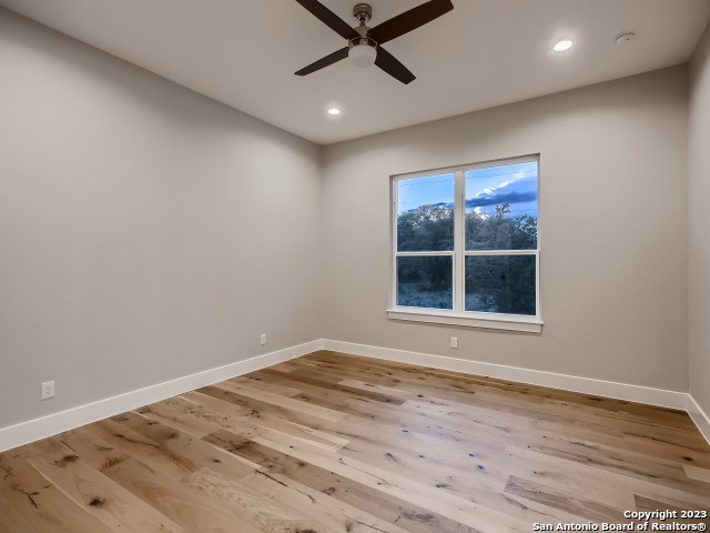 208 River Ridge Boerne, TX 78006 - Photo 20 of 38 a view of an empty room with a window and wooden floor