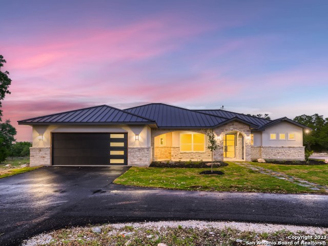 208 River Ridge Boerne, TX 78006 - Photo 2 of 38 a front view of a house with a garden and yard