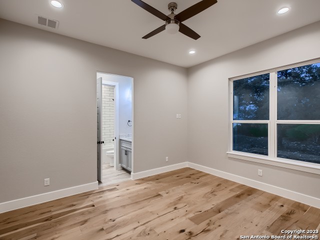 208 River Ridge Boerne, TX 78006 - Photo 21 of 38 an empty room with wooden floor and windows