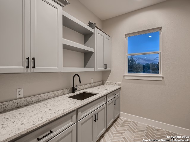 208 River Ridge Boerne, TX 78006 - Photo 23 of 38 a kitchen with a sink and cabinets