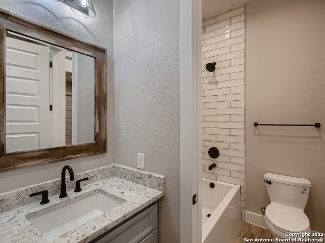 208 River Ridge Boerne, TX 78006 - Photo 24 of 38 a bathroom with a granite countertop sink toilet and shower