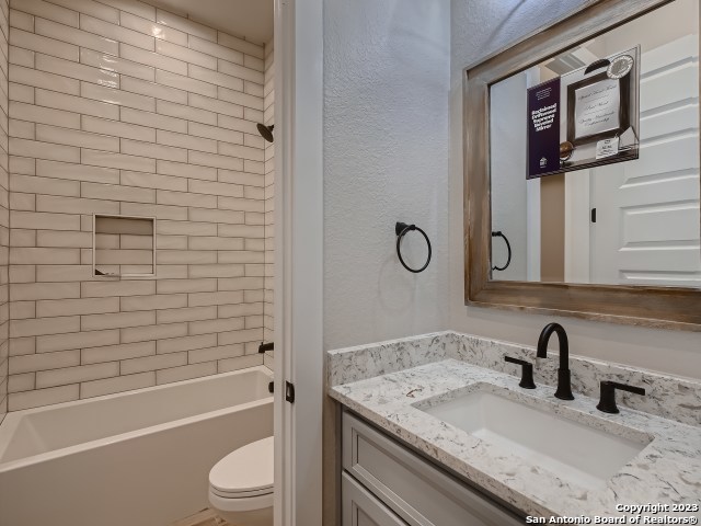 208 River Ridge Boerne, TX 78006 - Photo 25 of 38 a bathroom with a granite countertop sink toilet and shower