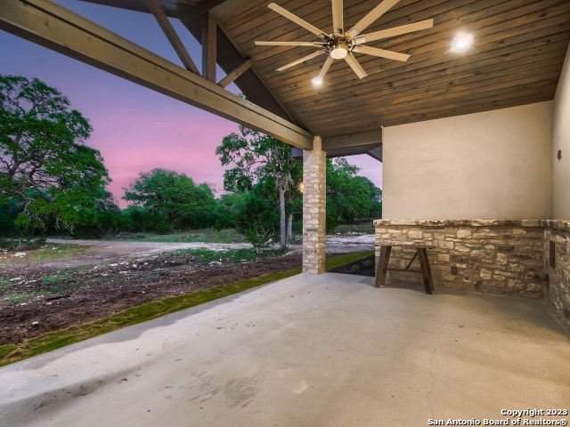208 River Ridge Boerne, TX 78006 - Photo 26 of 38 a view of a patio with a table and chairs under an umbrella
