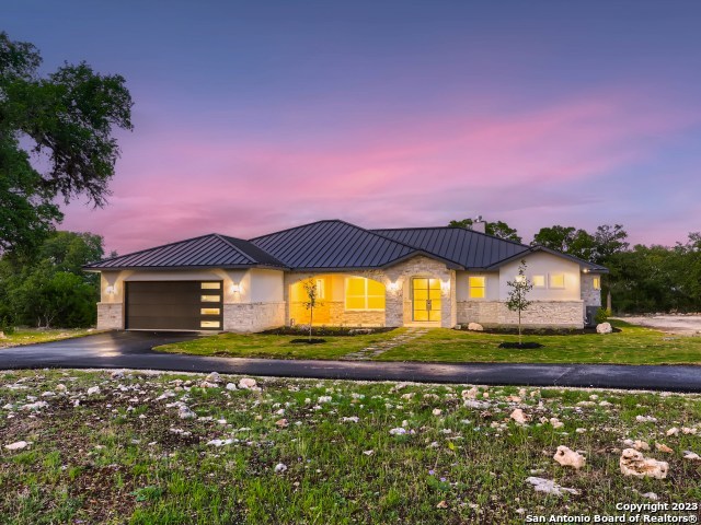 208 River Ridge Boerne, TX 78006 - Photo 3 of 38 a front view of a house with a yard and a large tree in the background
